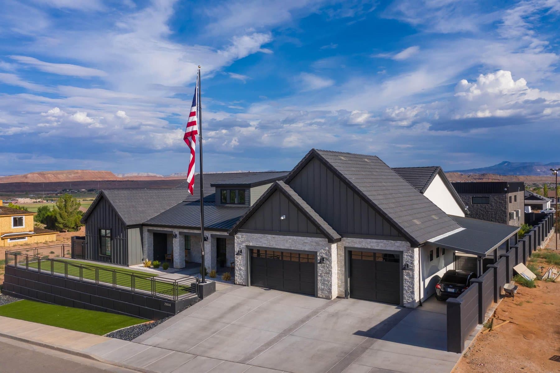 The Crimson Shadows Estate from the air, flag flying against the red cliffs