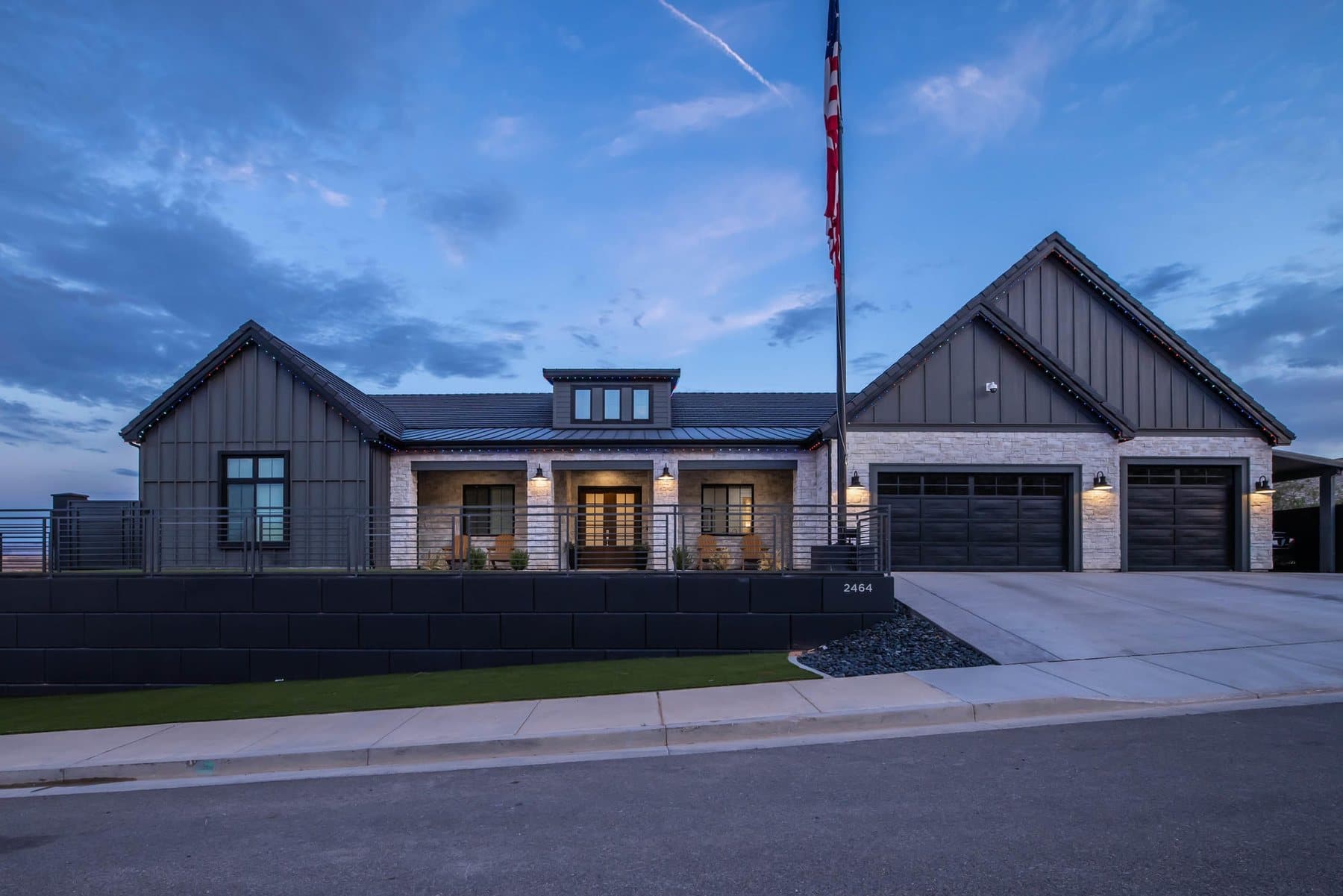 The Crimson Shadows Estate at dusk, porch and eaves lit