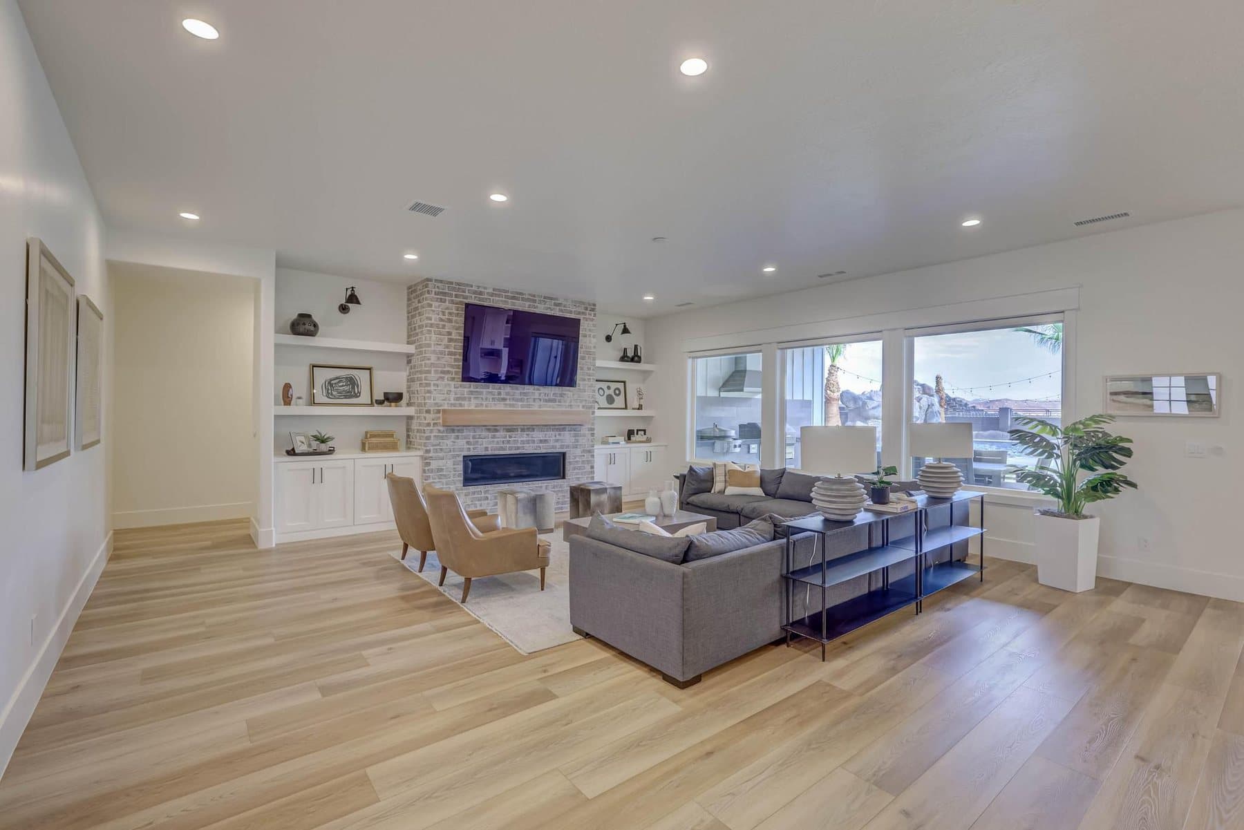 The great room, on a gas fireplace and open to the kitchen