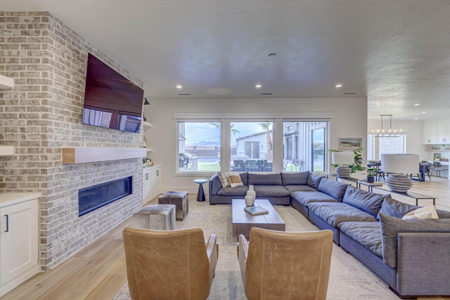 The great room, on a gas fireplace and open to the kitchen