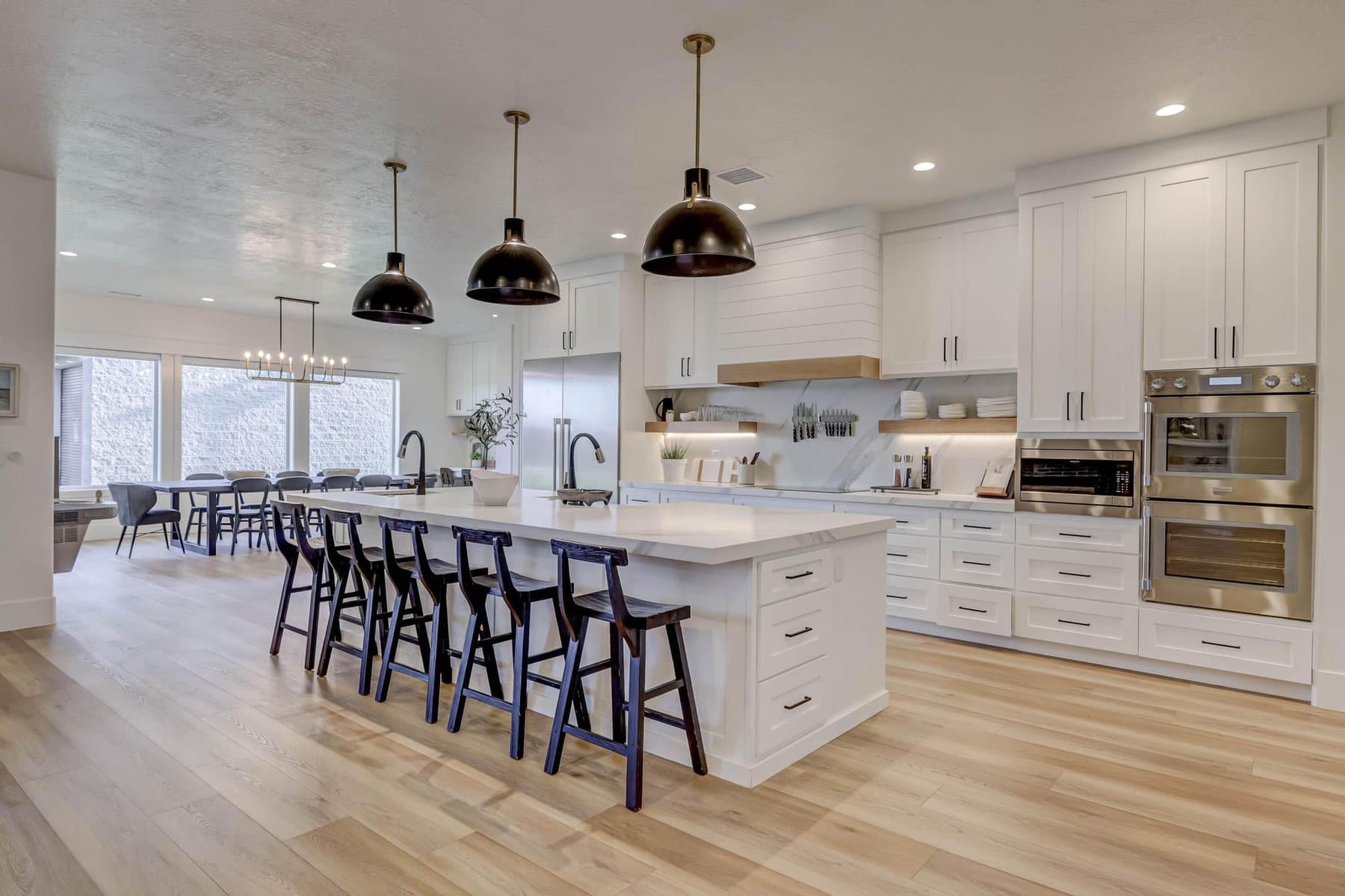 The kitchen — oversized quartz island, pendant lighting and bar seating
