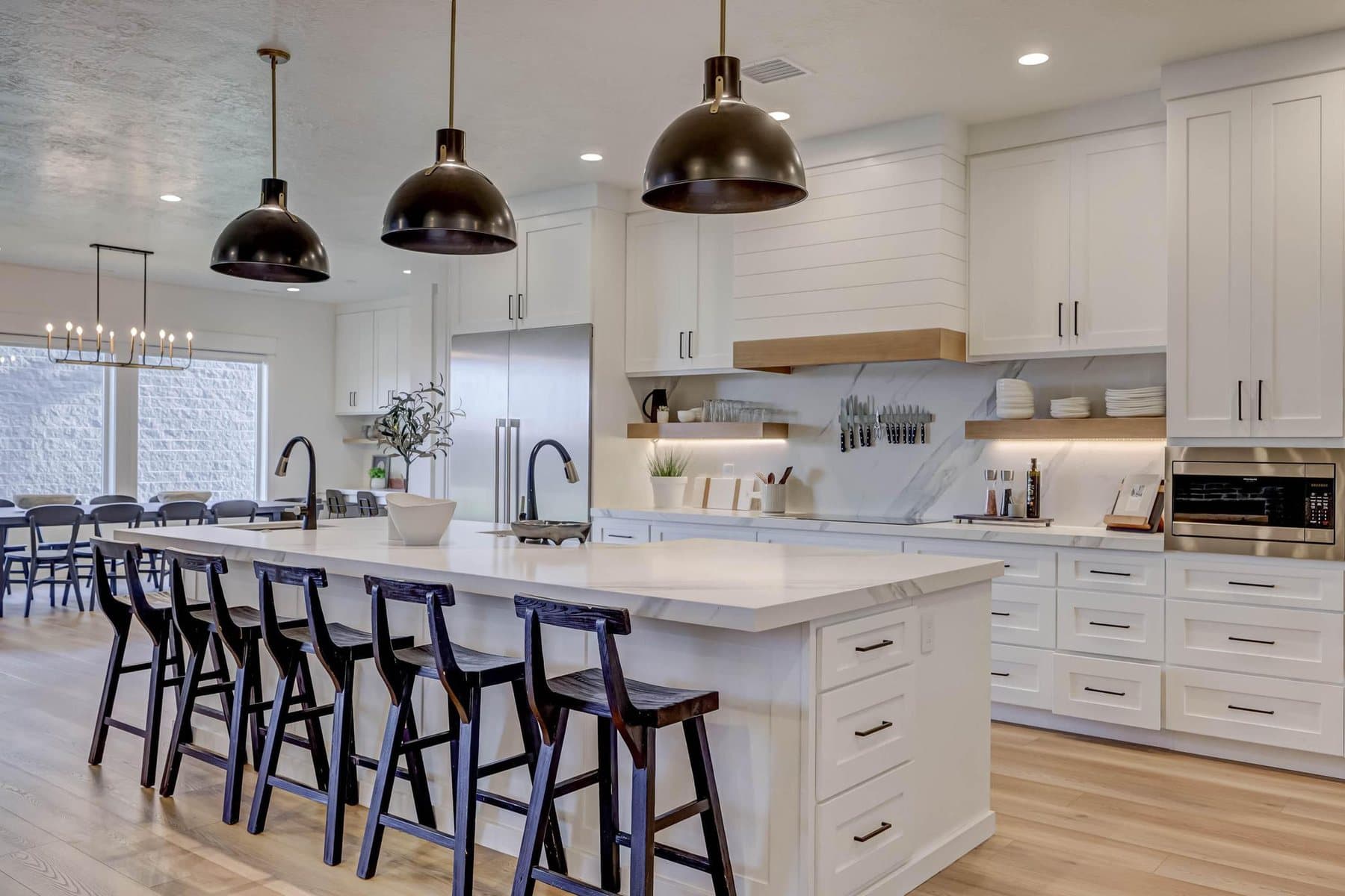 The kitchen — oversized quartz island, pendant lighting and bar seating