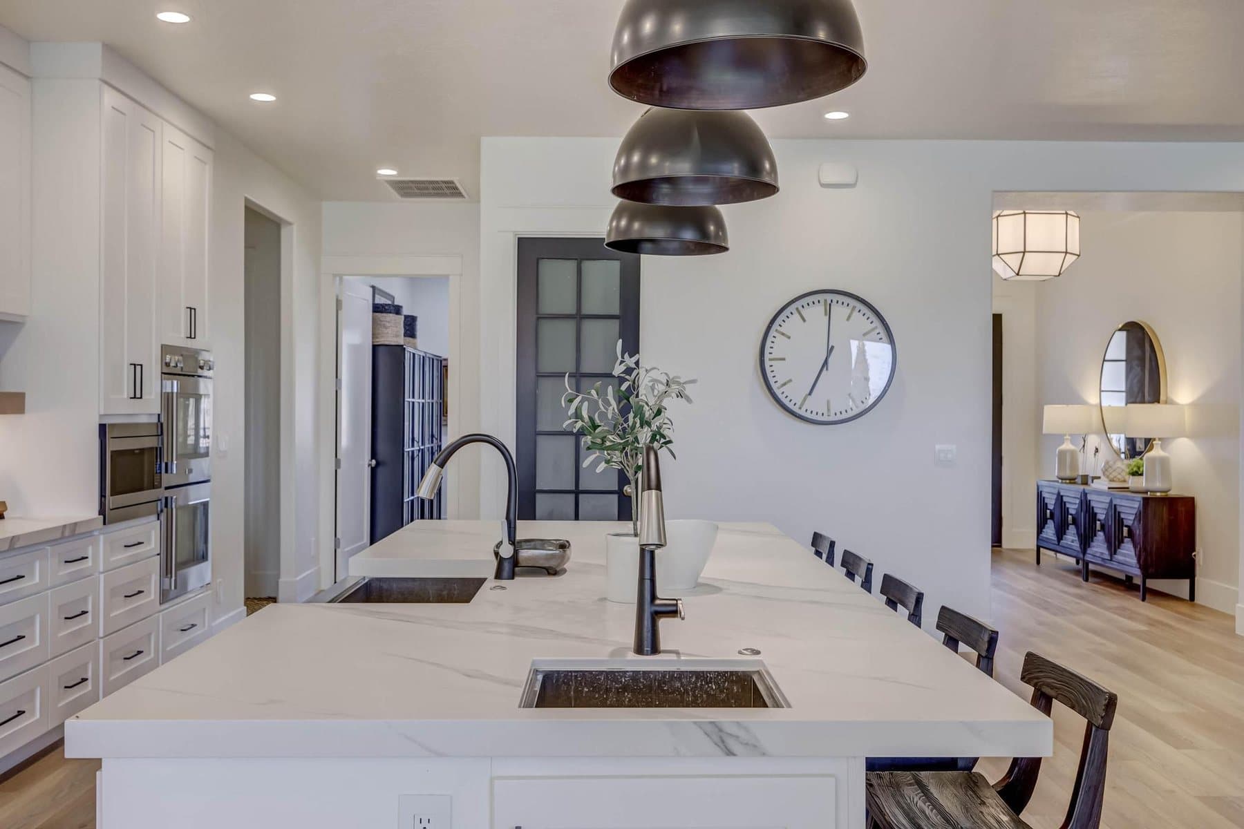 The kitchen — oversized quartz island, pendant lighting and bar seating