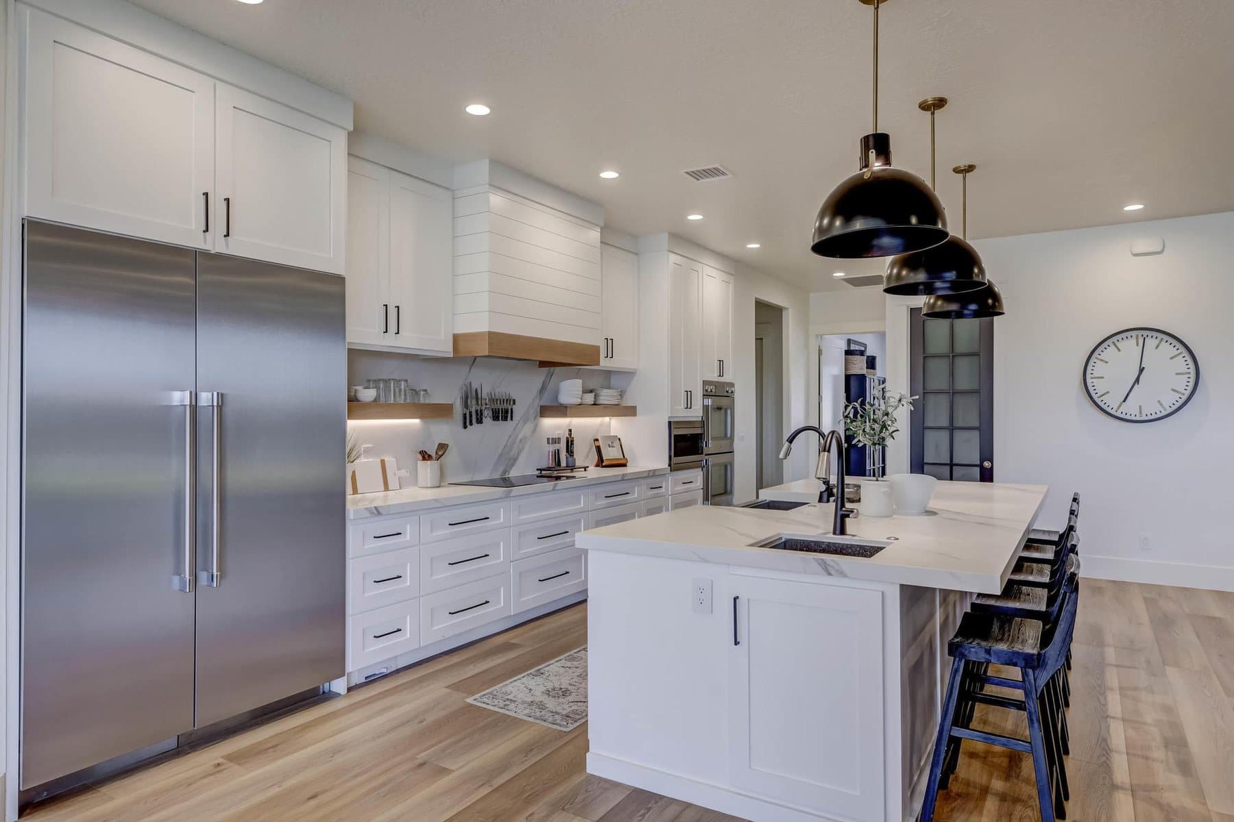 The kitchen — oversized quartz island, pendant lighting and bar seating