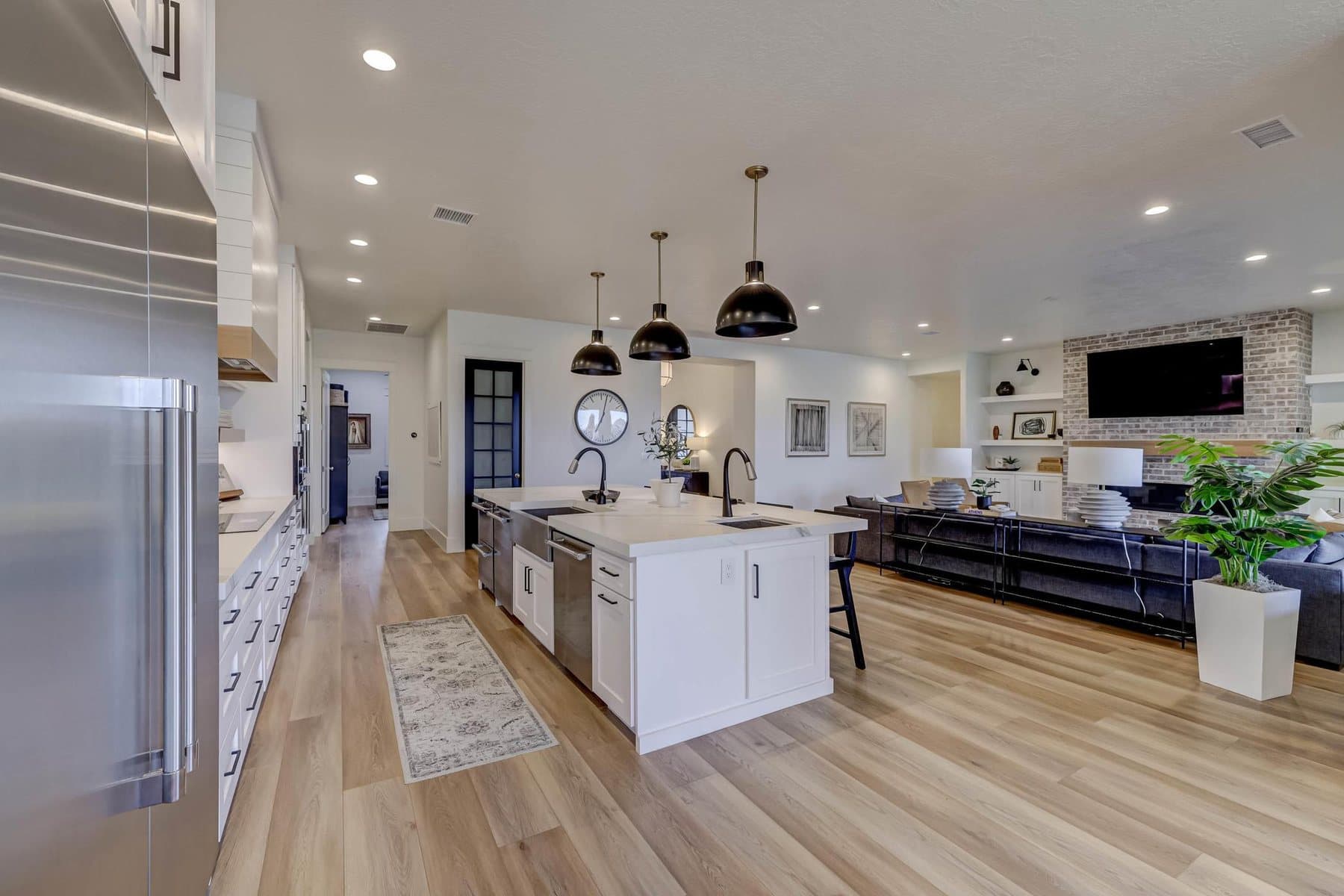 The kitchen — oversized quartz island, pendant lighting and bar seating