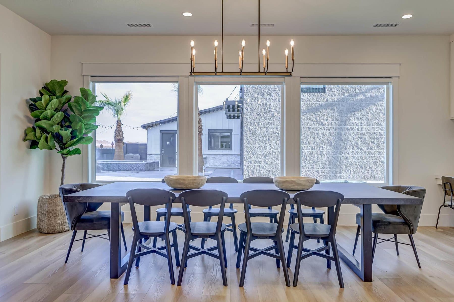 The dining room, table for ten under a linear chandelier