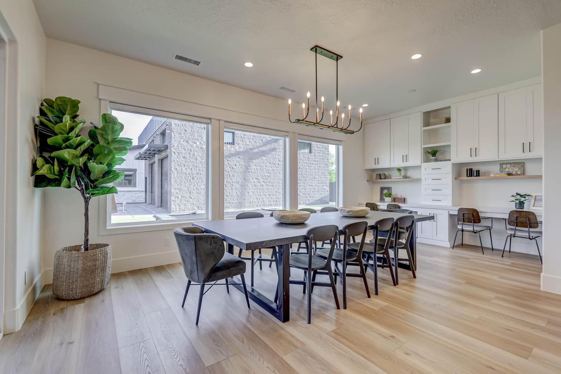 The dining room, table for ten under a linear chandelier