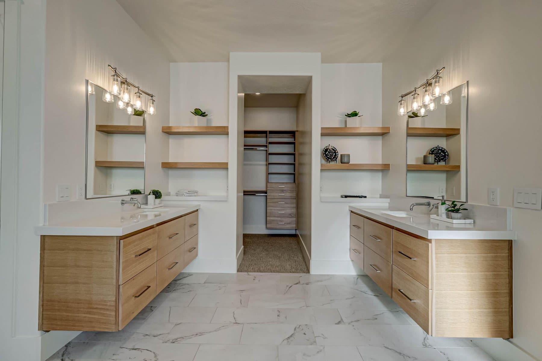 The primary bath — double vanities, freestanding tub and tiled walk-in shower