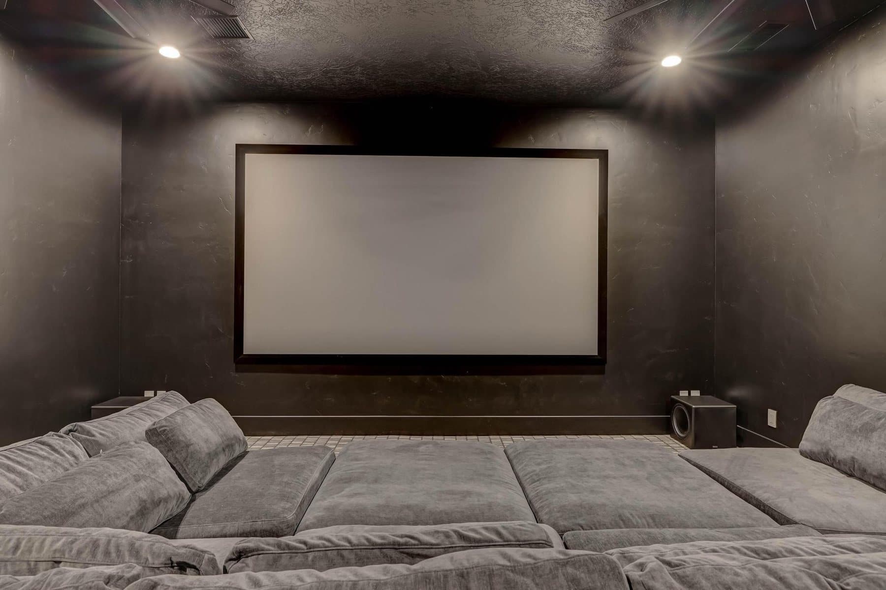 The theatre room, tiered seating facing the screen
