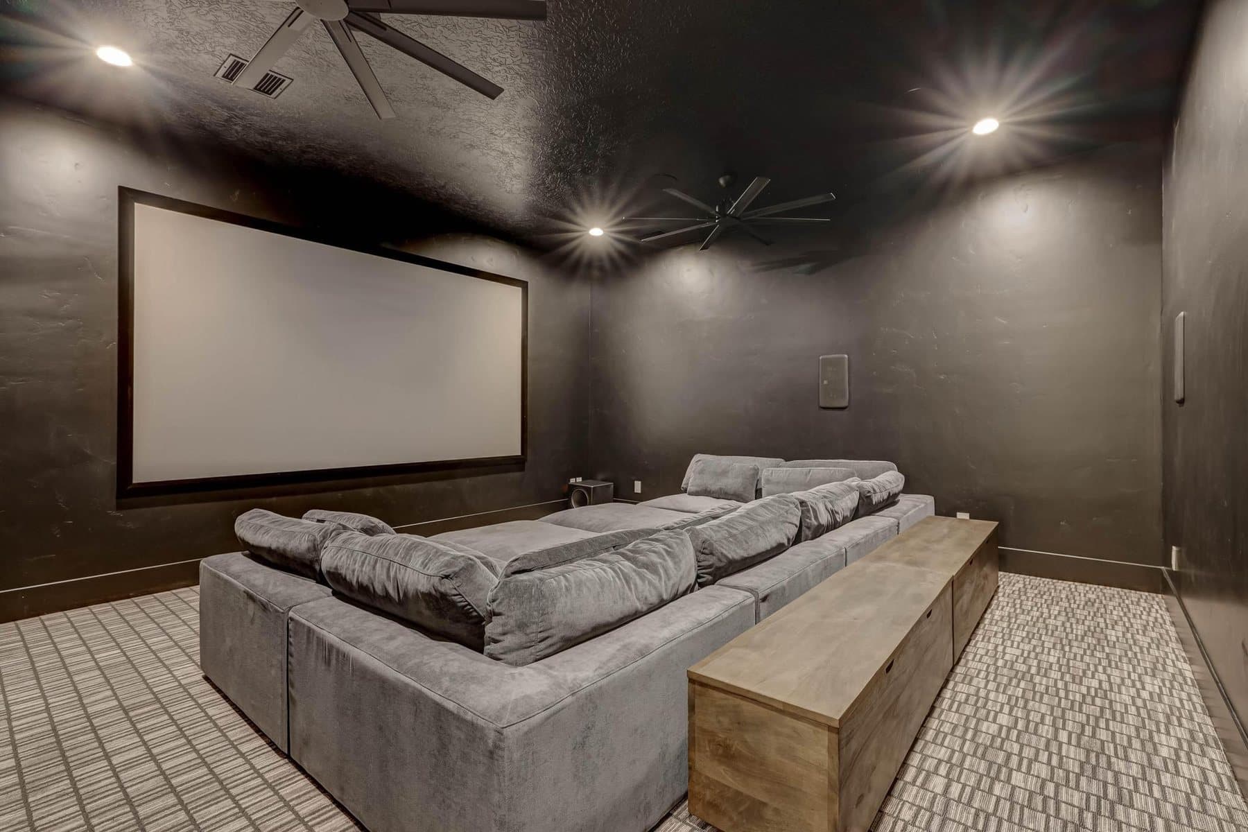 The theatre room, tiered seating facing the screen