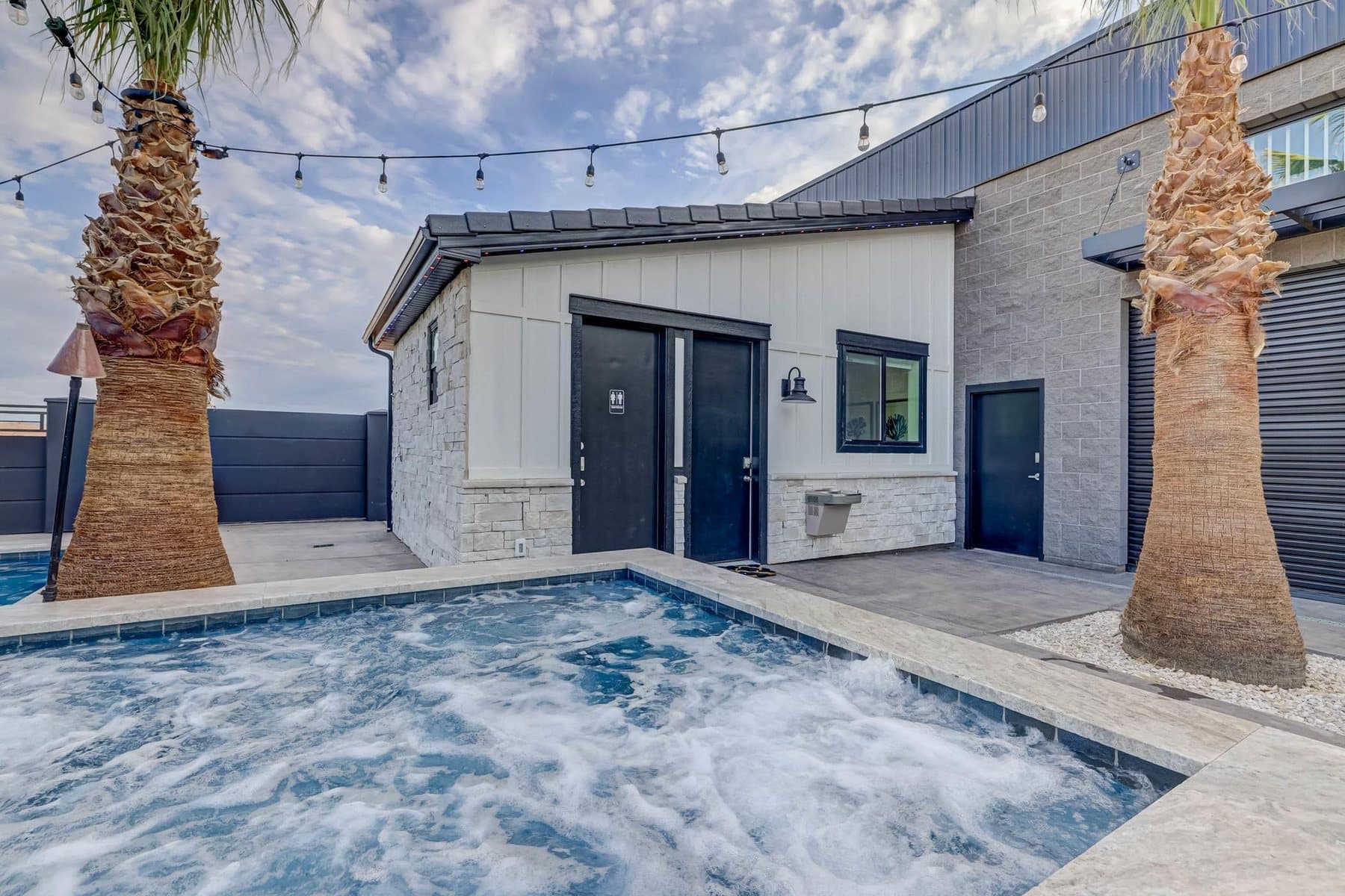 The pool deck with the detached recreation building beyond
