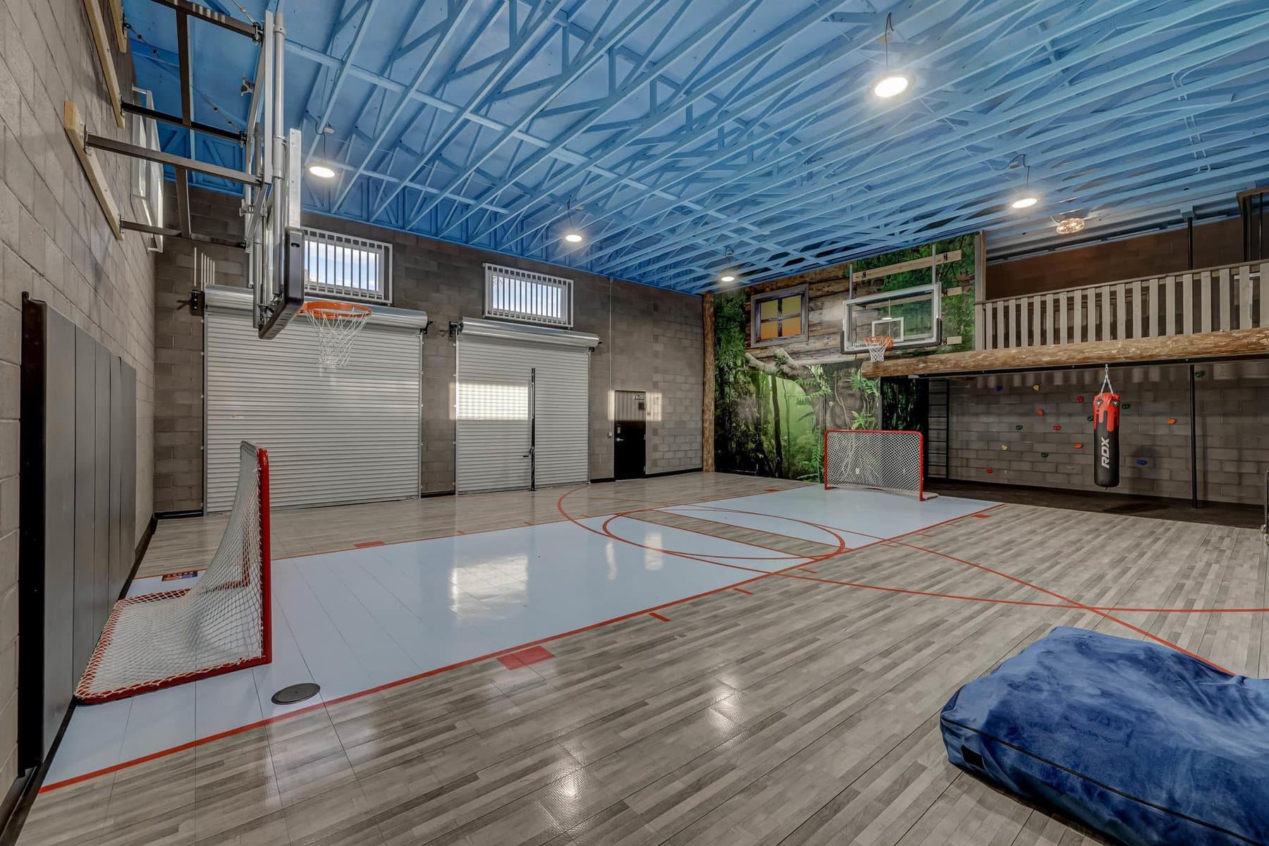 The indoor sport court in the rec building — climbing wall, slide and roll-up doors