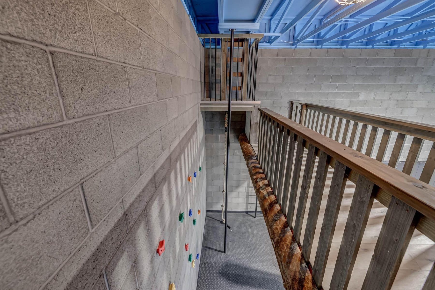 The indoor sport court in the rec building — climbing wall, slide and roll-up doors