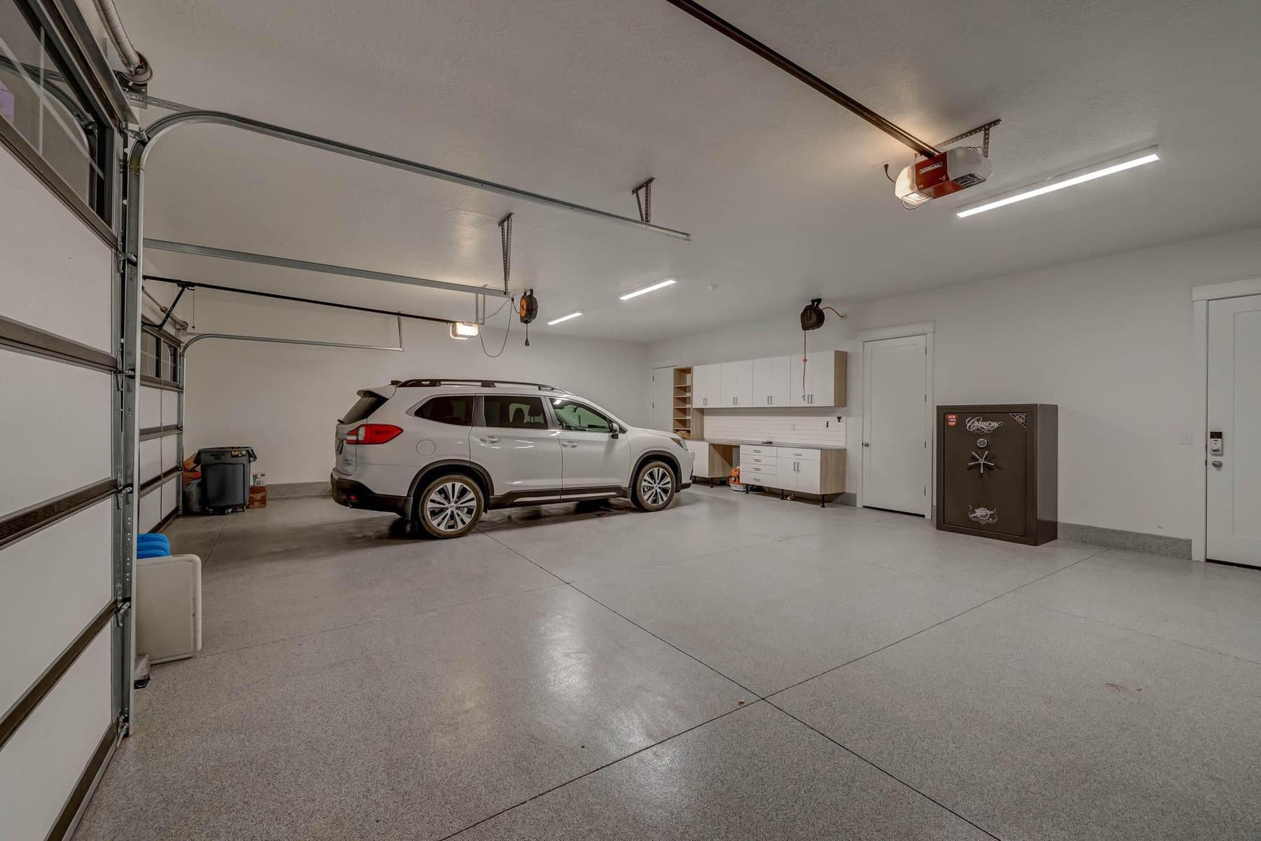 The garage, epoxy floor and custom cabinets
