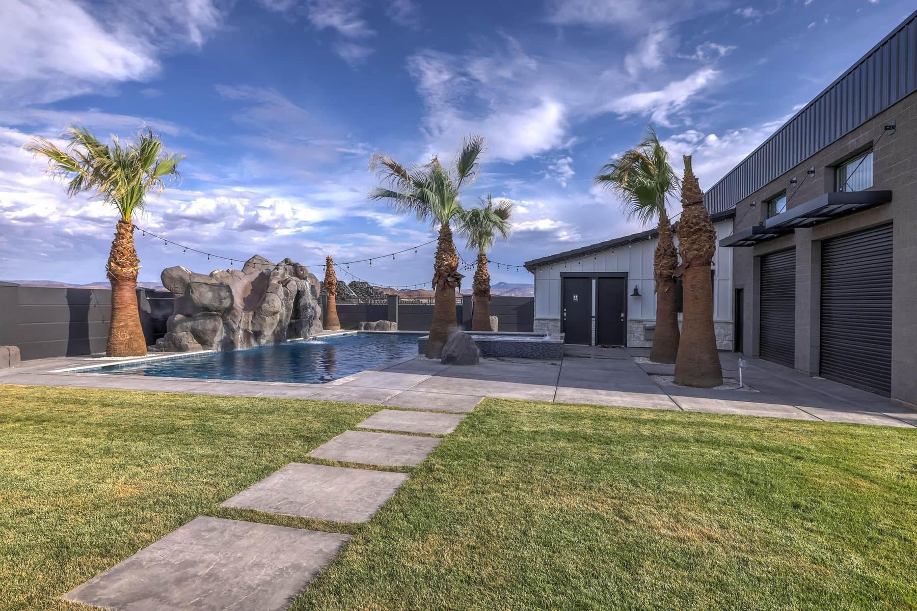 The 20 by 50 foot sports pool with its rock feature and mature palms