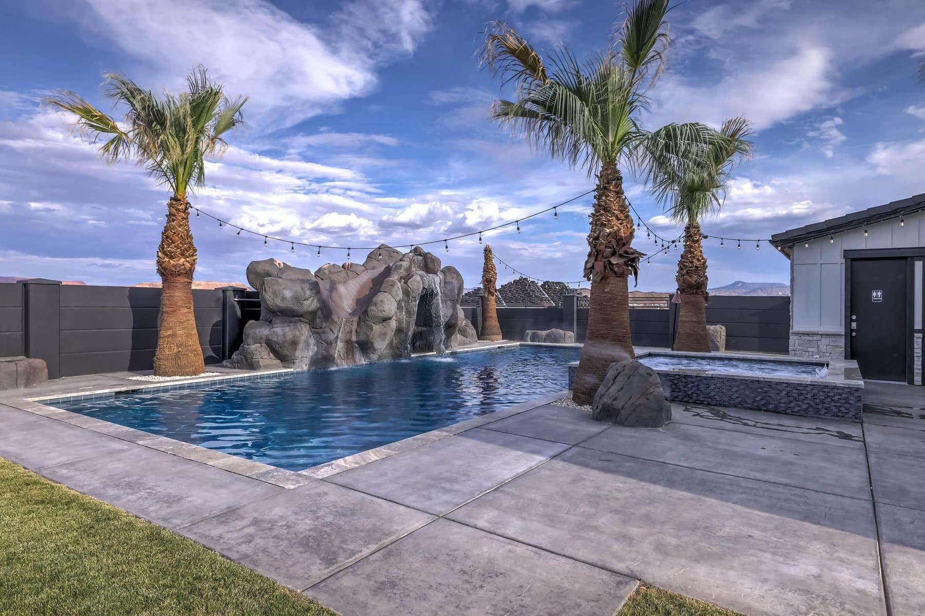 The 20 by 50 foot sports pool with its rock feature and mature palms