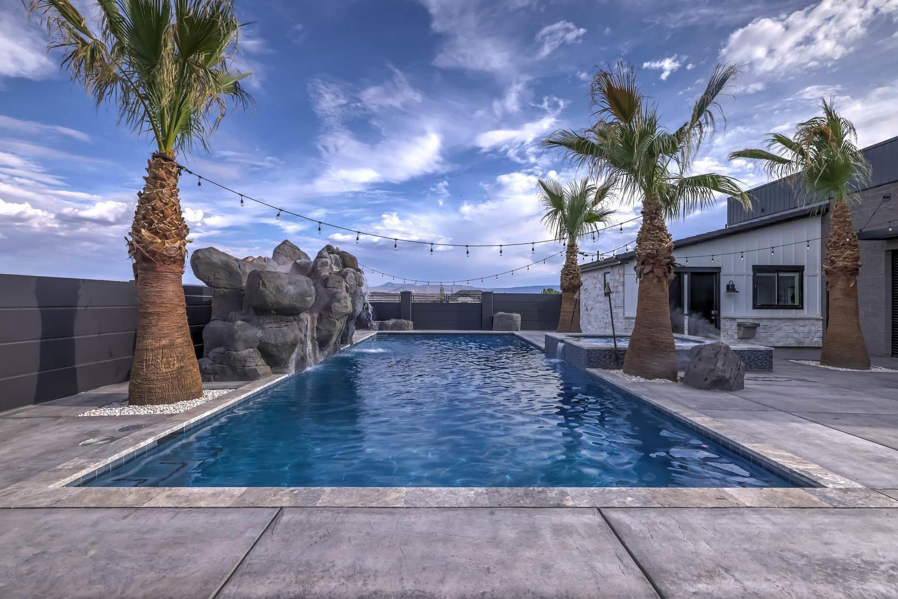 The 20 by 50 foot sports pool with its rock feature and mature palms