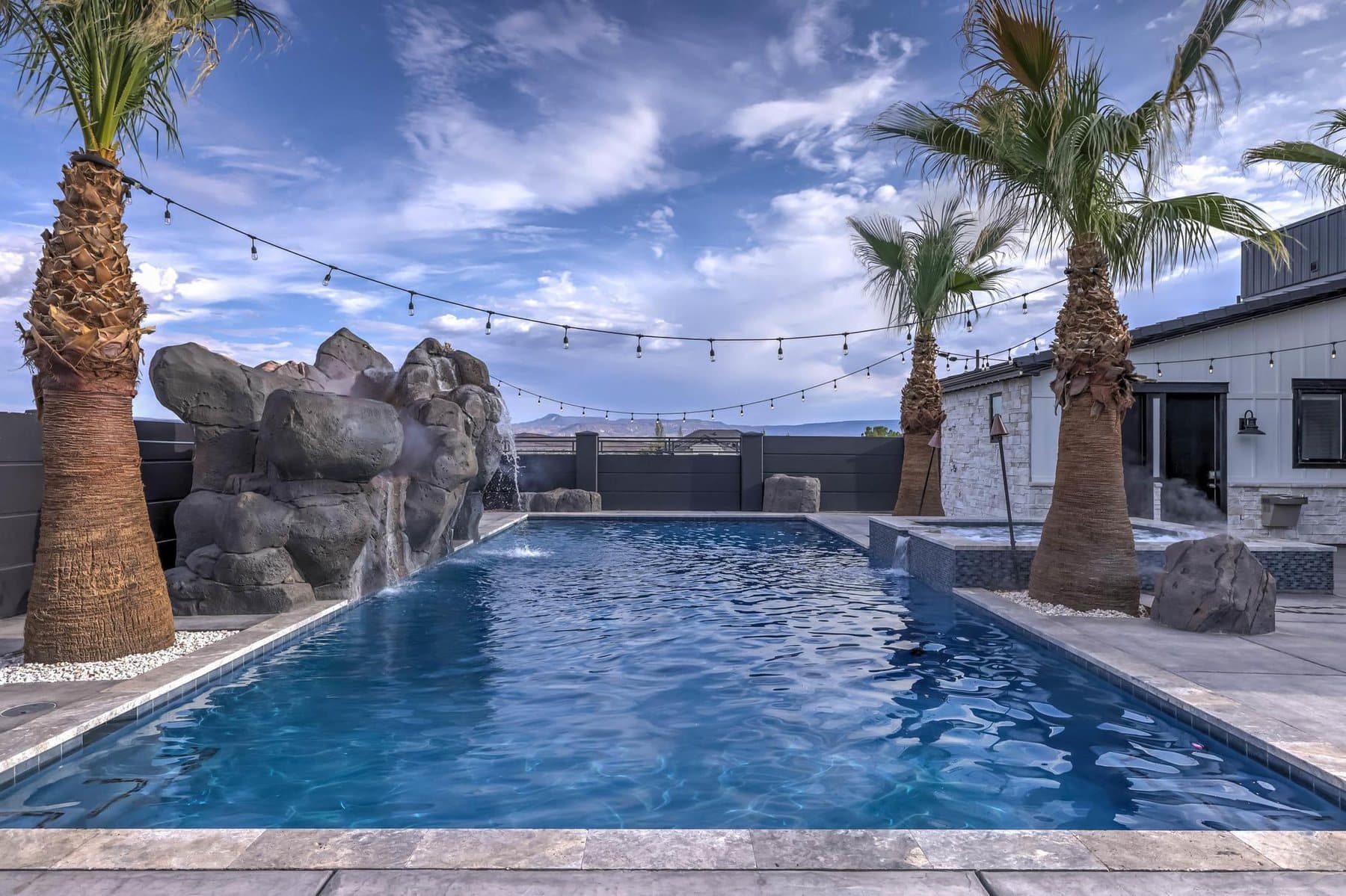 The 20 by 50 foot sports pool with its rock feature and mature palms