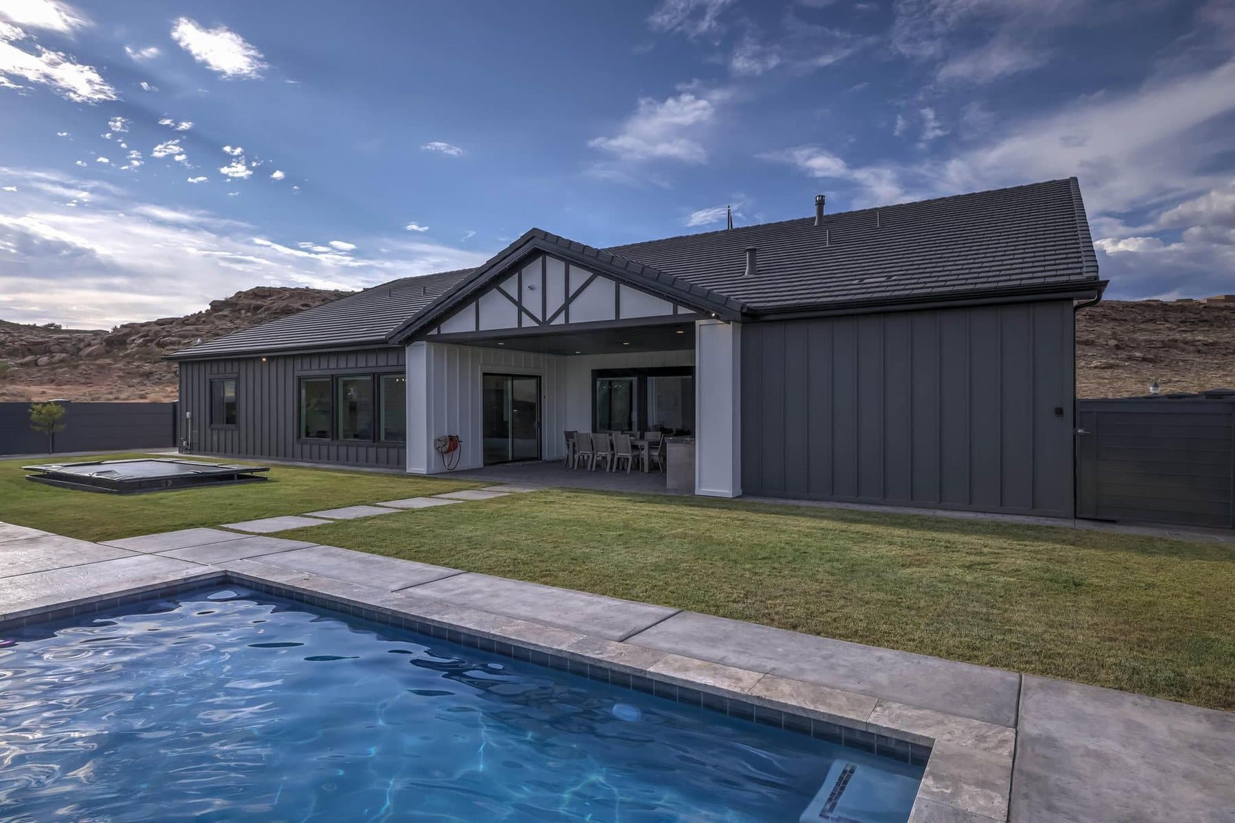 The 20 by 50 foot sports pool with its rock feature and mature palms
