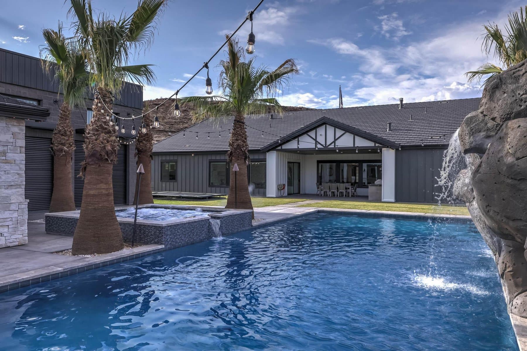 The 20 by 50 foot sports pool with its rock feature and mature palms