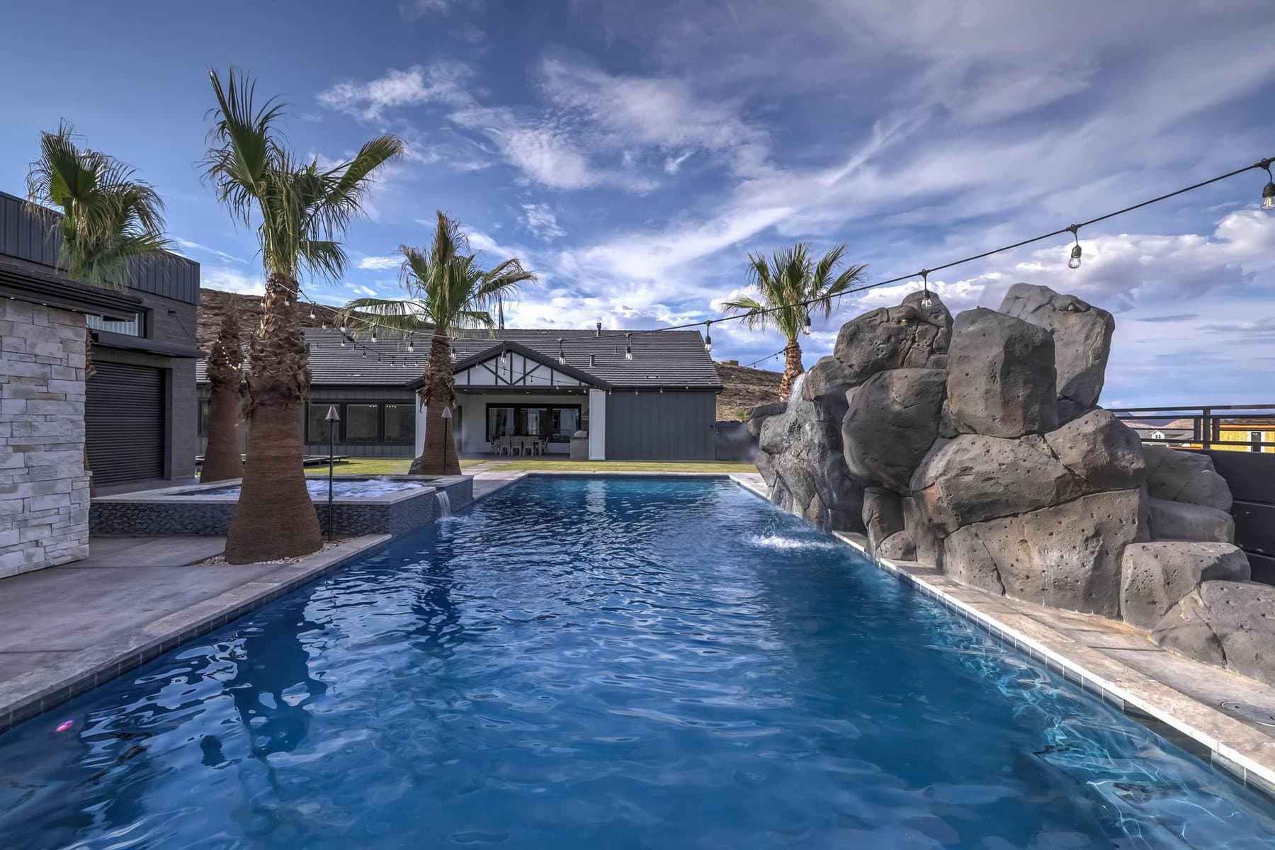 The 20 by 50 foot sports pool with its rock feature and mature palms