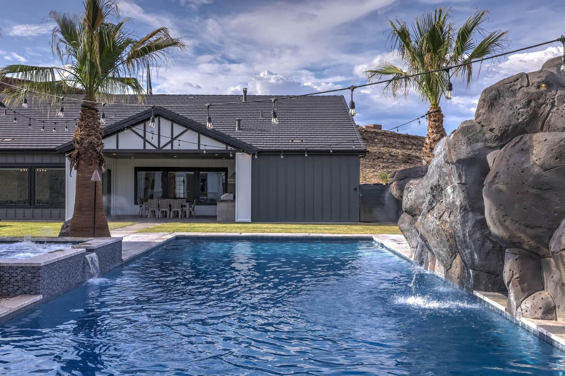 The 20 by 50 foot sports pool with its rock feature and mature palms