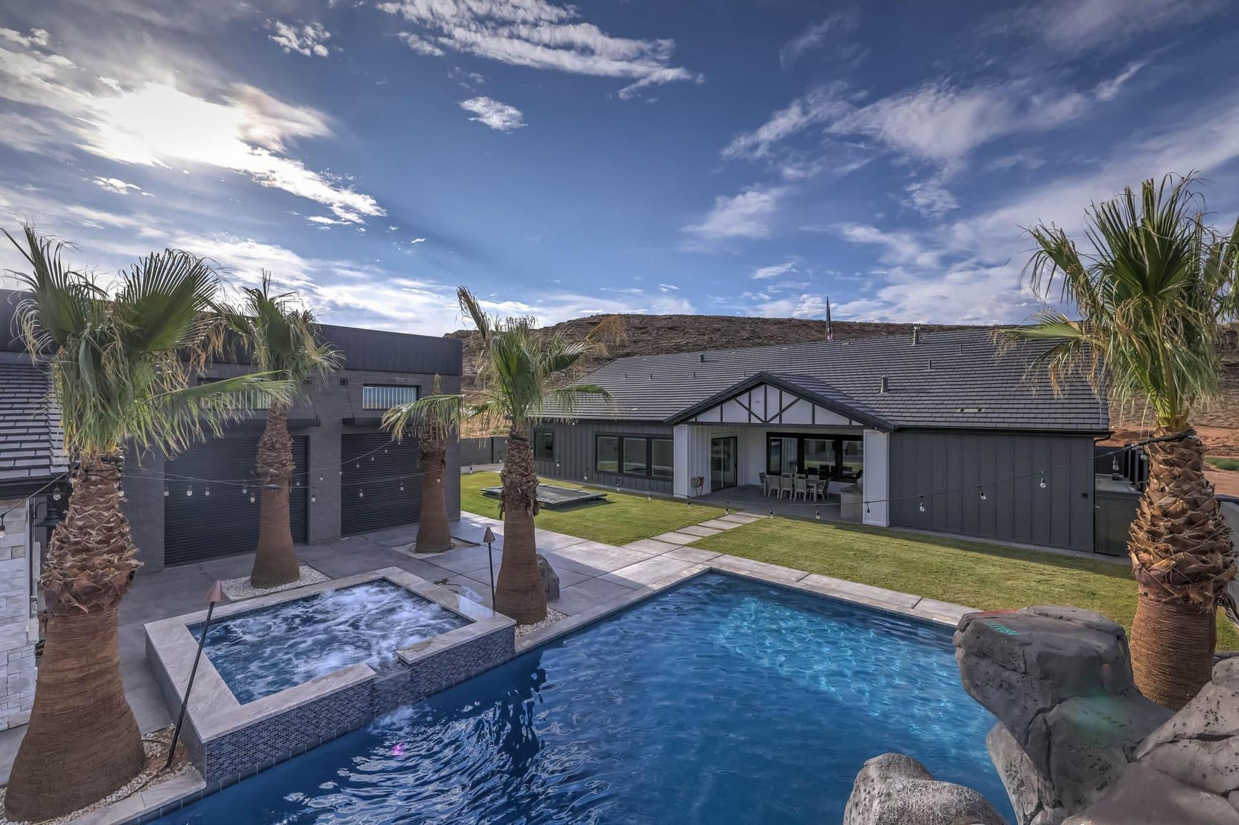 The 20 by 50 foot sports pool with its rock feature and mature palms