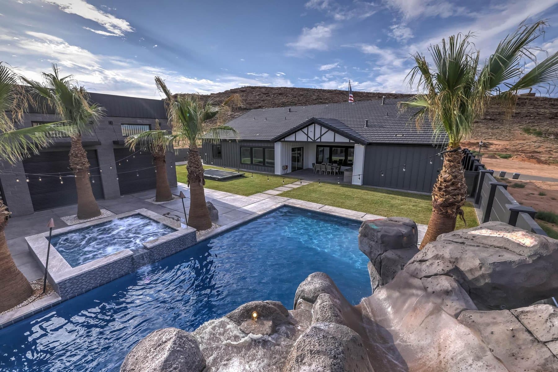 The 20 by 50 foot sports pool with its rock feature and mature palms