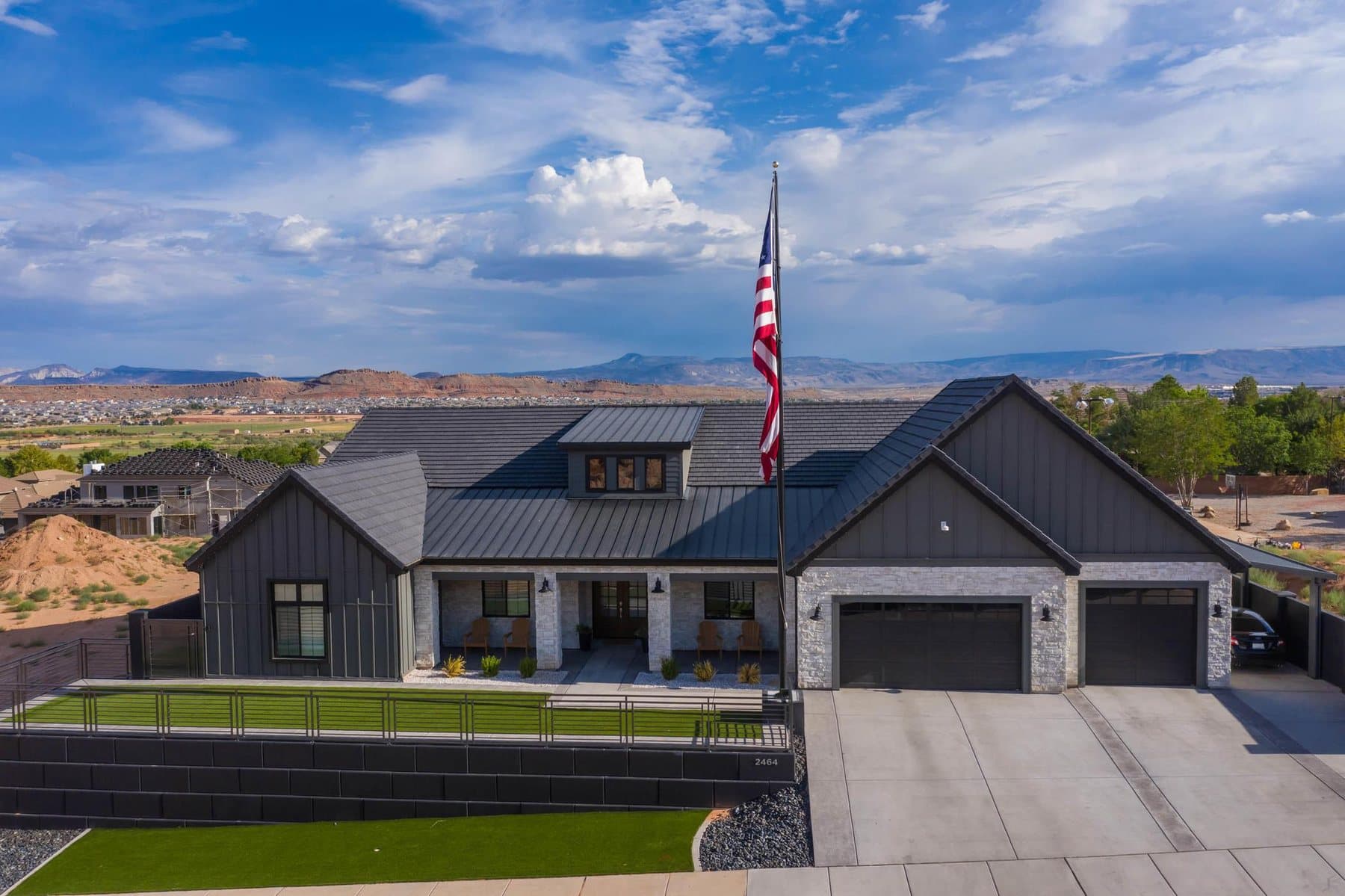 The property from the air — house, pool and courts against the Little Valley ridgeline