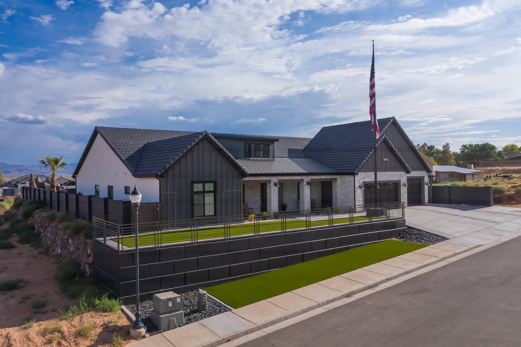 The property from the air — house, pool and courts against the Little Valley ridgeline