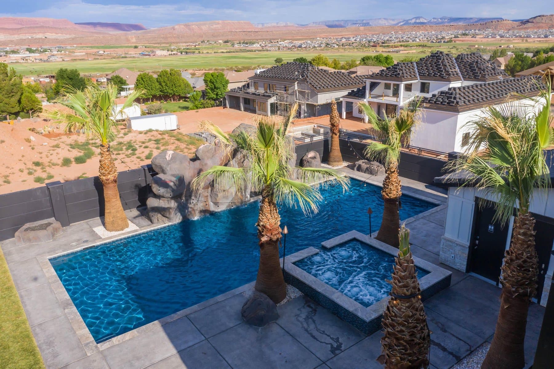 The property from the air — house, pool and courts against the Little Valley ridgeline