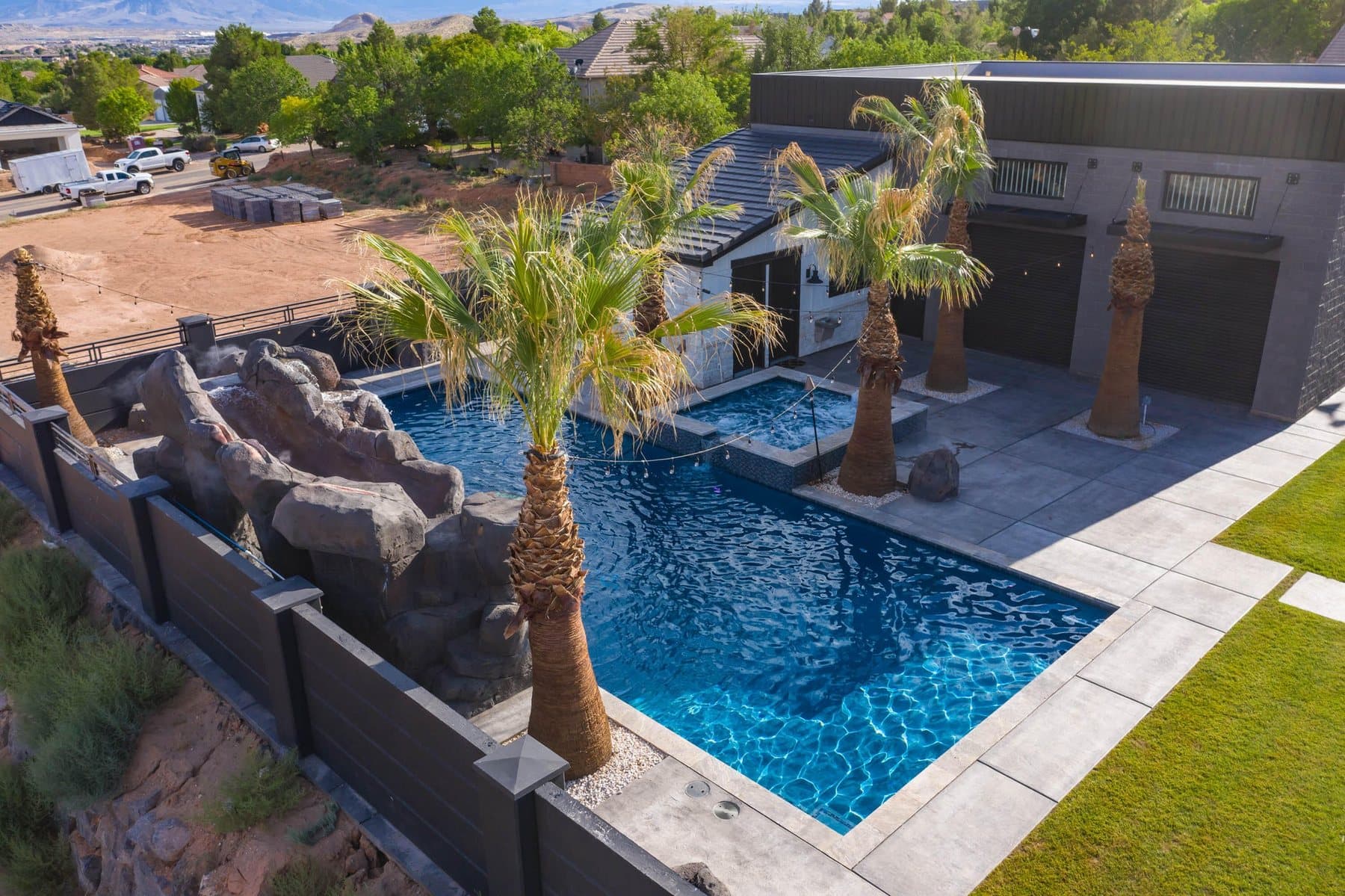 The property from the air — house, pool and courts against the Little Valley ridgeline