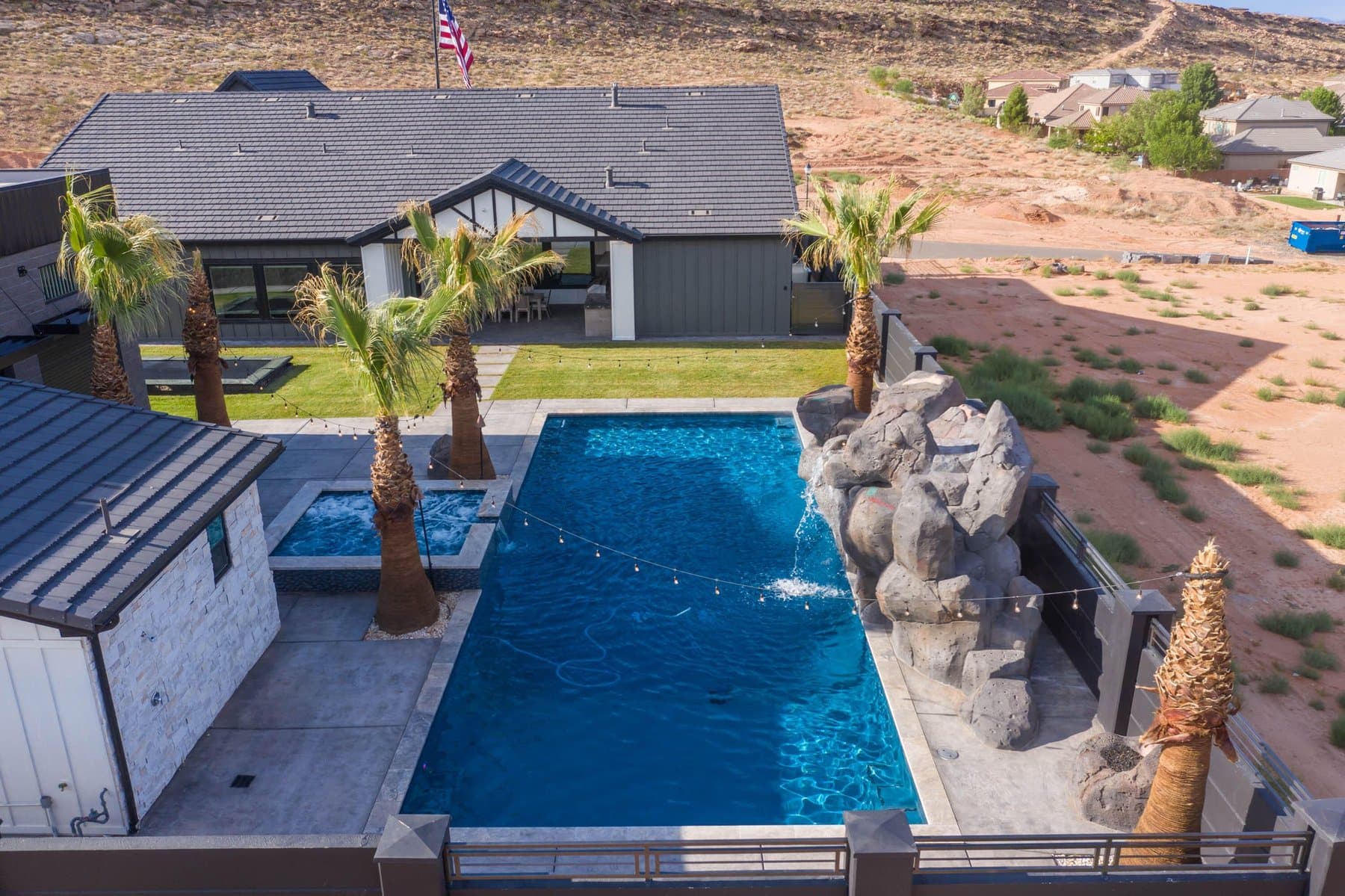 The property from the air — house, pool and courts against the Little Valley ridgeline