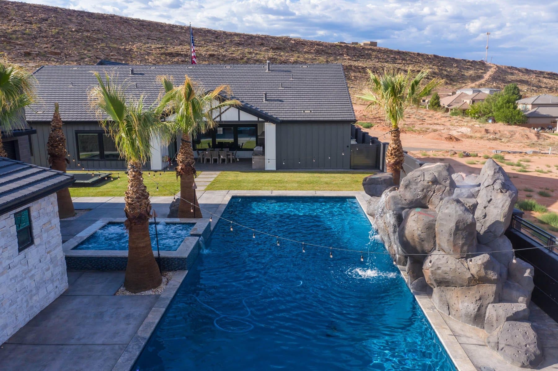 The property from the air — house, pool and courts against the Little Valley ridgeline