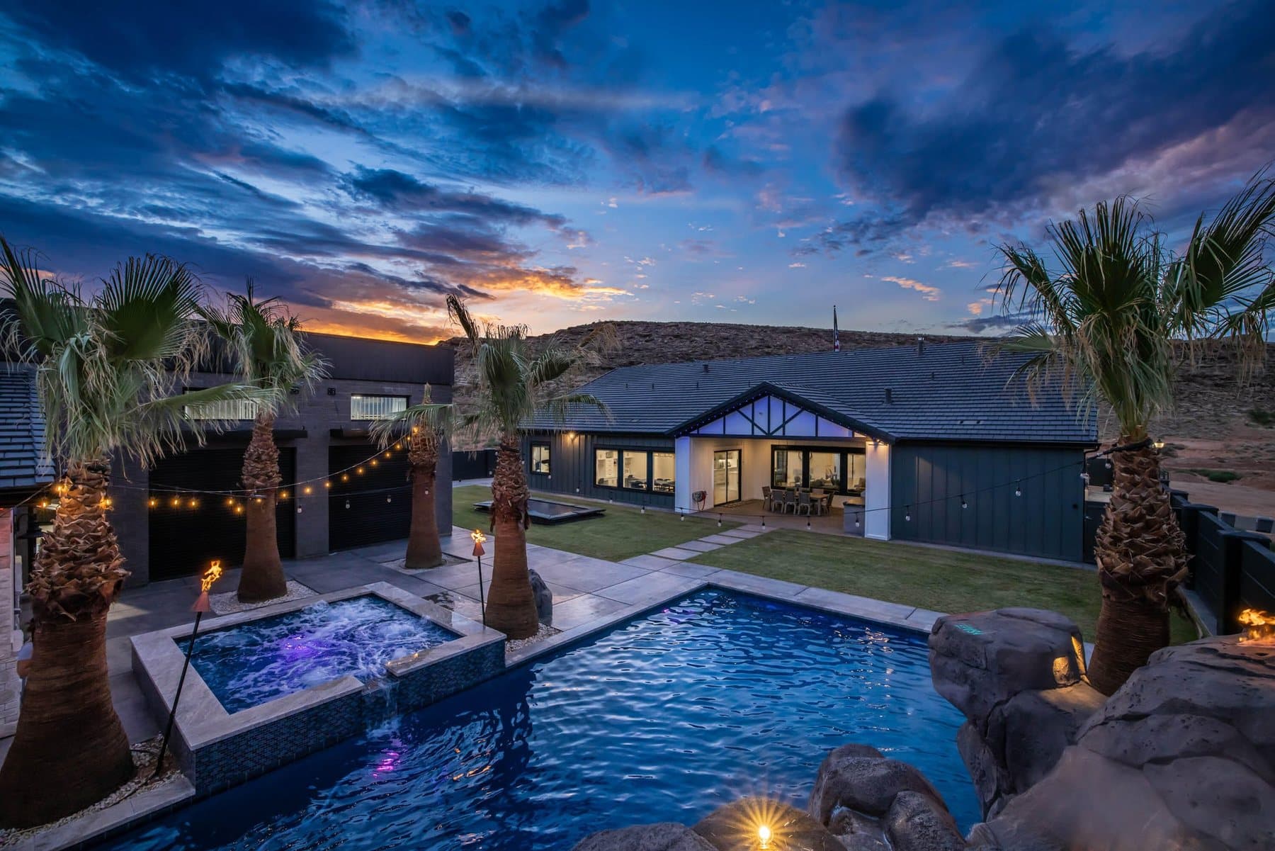 The pool at dusk, lit under string lights