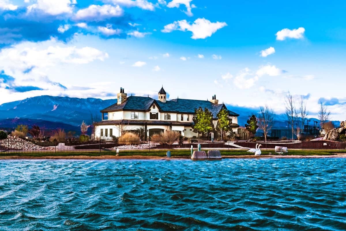 The Ridgeline House seen across the water, with the Pine Valley Mountains behind it