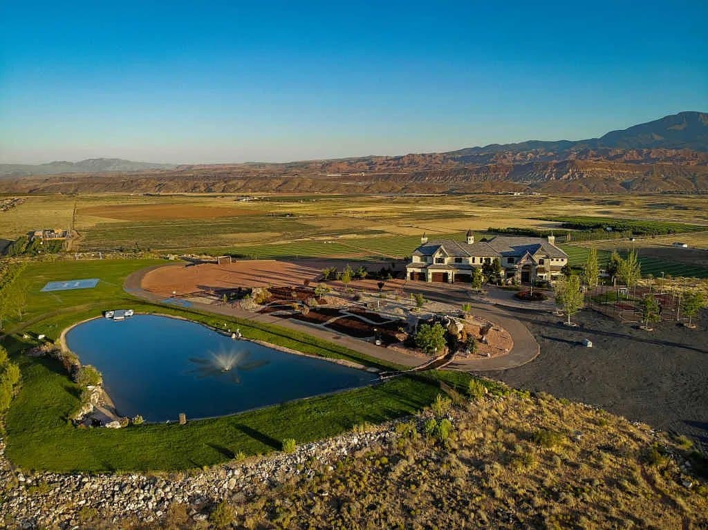The estate from the air — pond, lawns and the mesa dropping away beyond