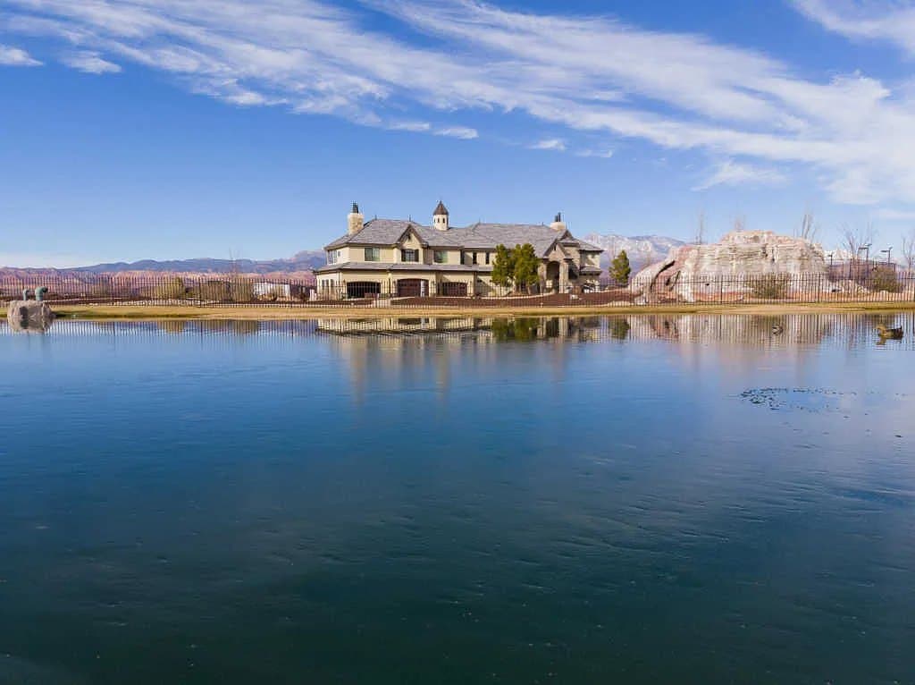 The house seen across Sand Hollow, red rock behind it
