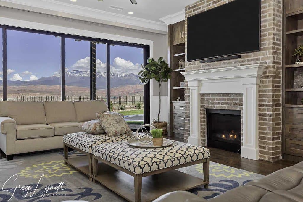 The great room fireplace, glazing out to the valley