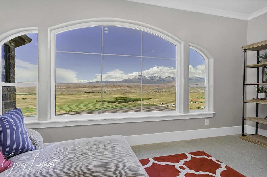 A bedroom under an arched window