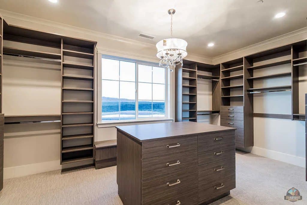 The walk-in closet, island and full-height shelving
